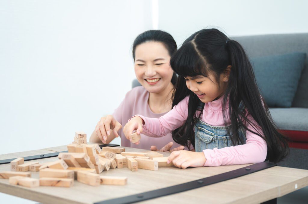 children development education, mother and daughter family playing and learning fun at home, young woman and eltern teacher are happy smiling together, little cute girl childhood concept